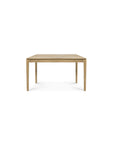 The Ethnicraft Bok Extendable Dining Table in solid oak features a simple, rectangular design with four straight legs, displayed against a plain white background.