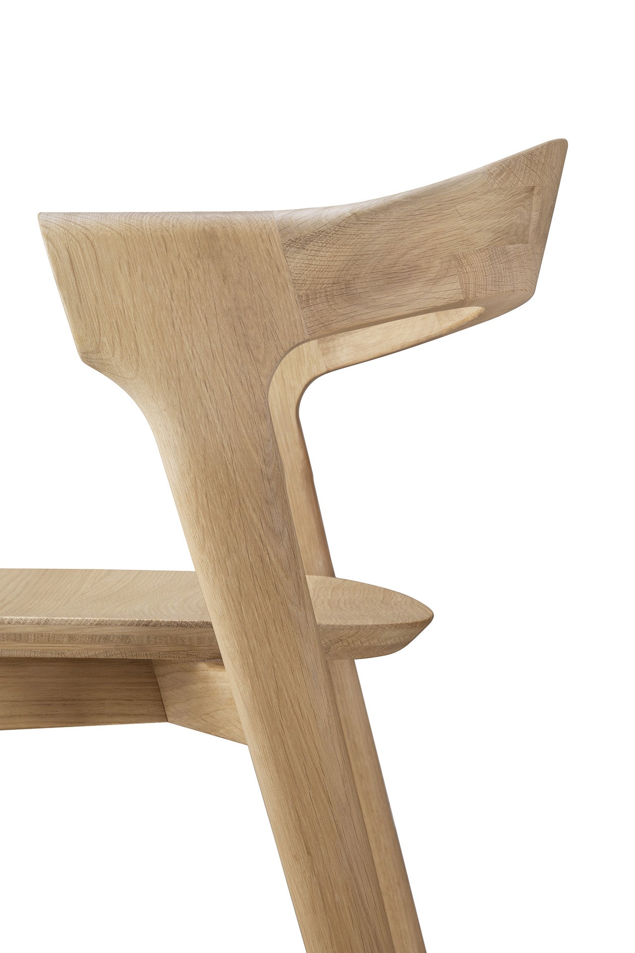 Close-up side view of the Ethnicraft Bok counter stool, featuring a smooth, minimalist design in solid oak with an angled backrest and clean lines, shown against a white background.