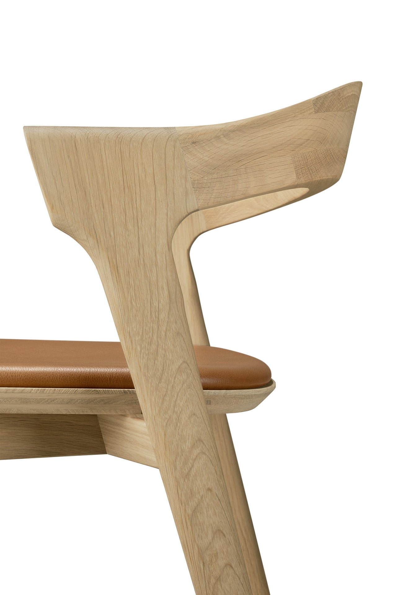Side view of the Ethnicraft Bok bar stool in solid oak, featuring a curved backrest and brown cushioned seat with clean lines and minimalist design, set against a white background.