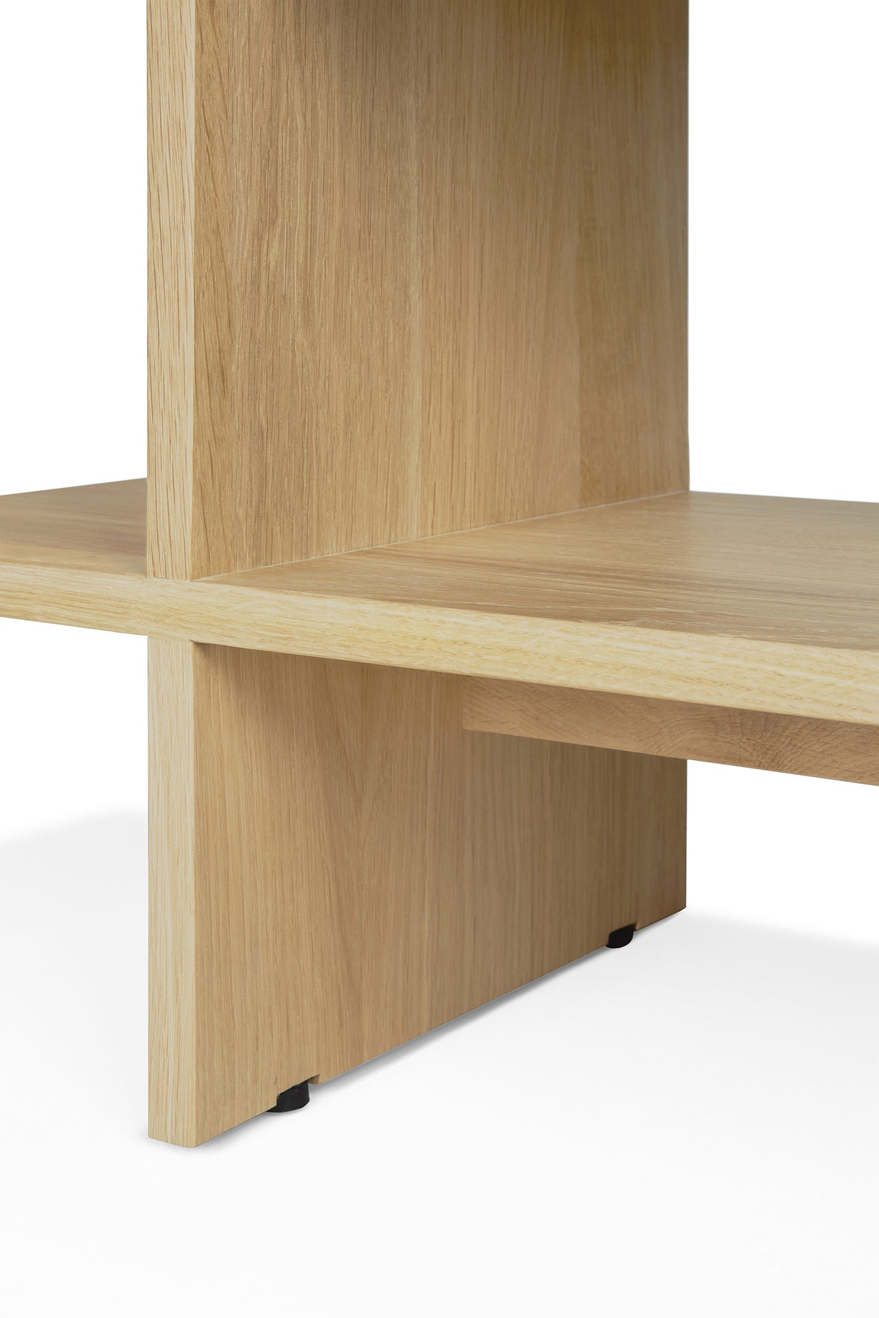Close-up of intersecting flat oak panels forming the Kabuki Side Table by Ethnicraft, featuring a minimalist design with clean lines and a natural finish, set against a white background.