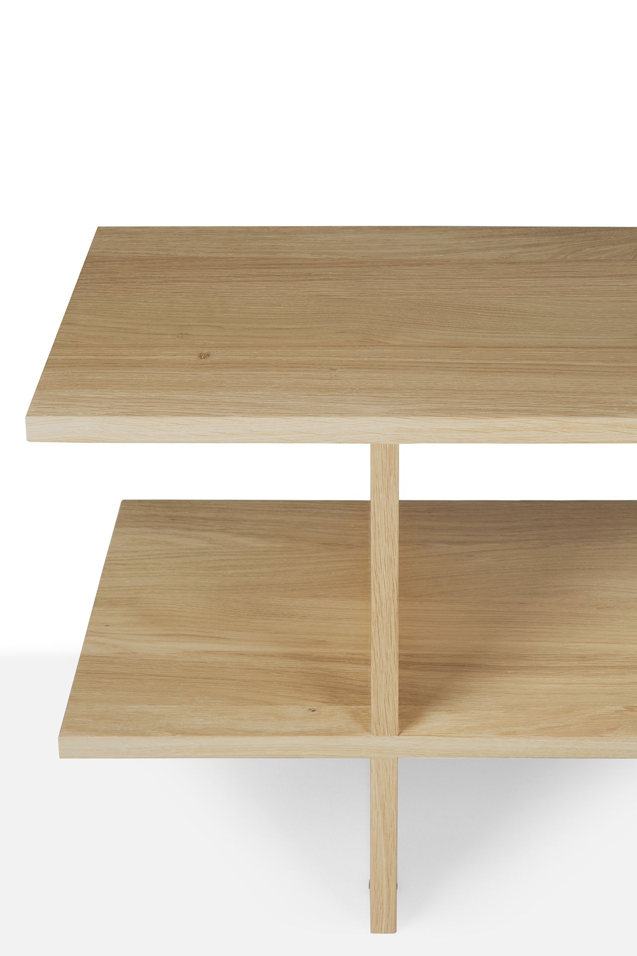 The Ethnicraft Kabuki Side Table - Oak is a minimalist wooden piece crafted from solid oak, featuring two rectangular shelves and a central vertical divider, shown on a white background.