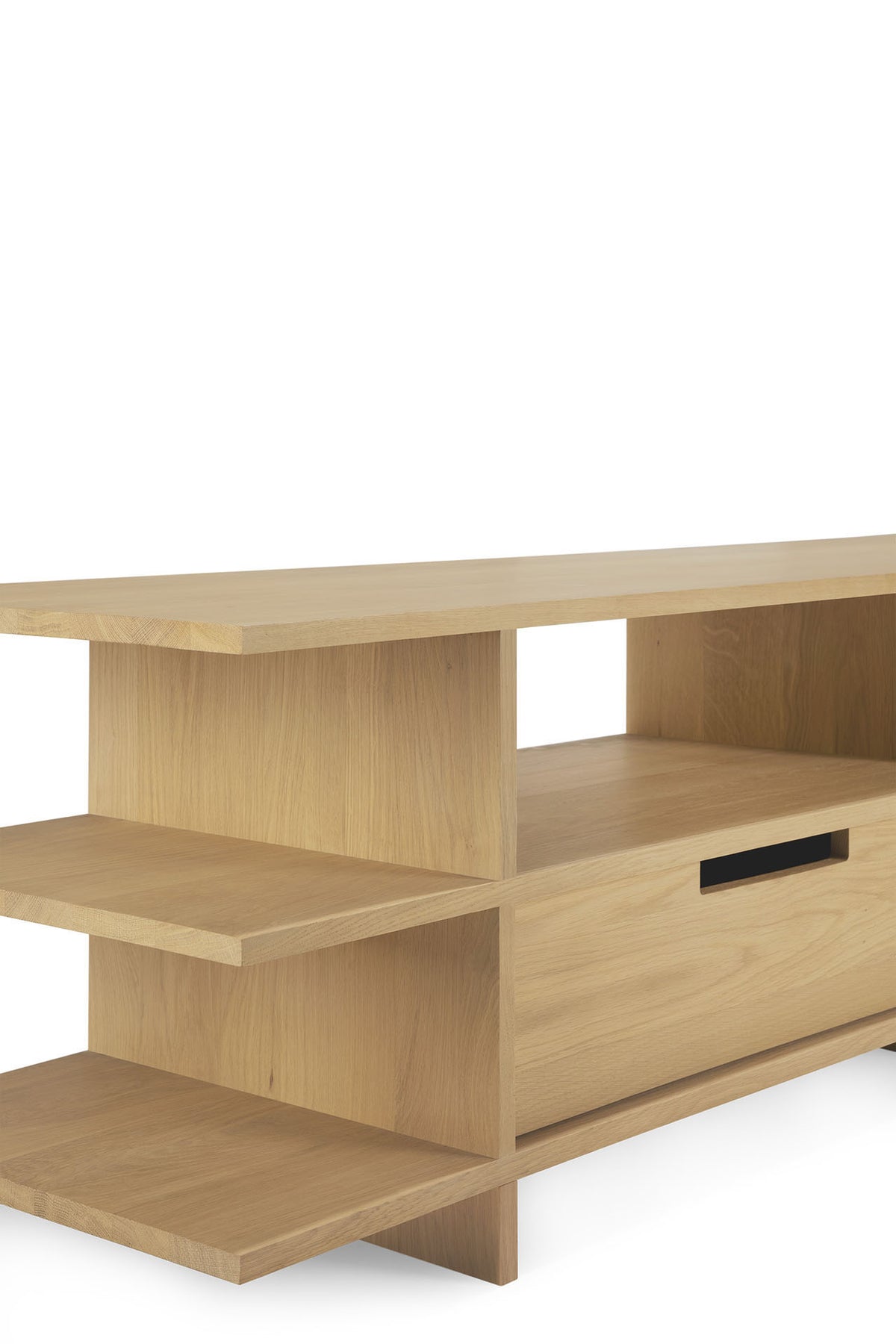 Ethnicraft Kabuki TV cupboard in light oak, featuring open shelves on the left, a solid top, and a drawer with a black handle on the right, set against a plain white background.