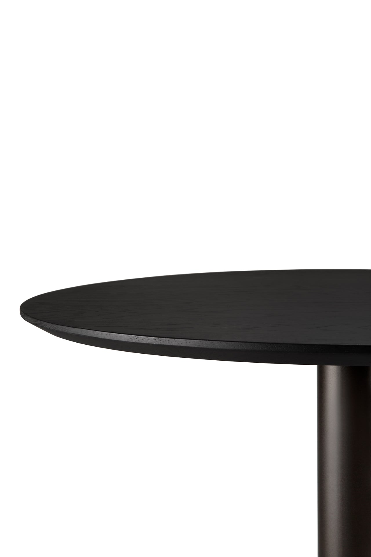 Close-up of the Ethnicraft Blend Dining Table - Black Oak, showcasing its modern round black top and cylindrical base against a plain white background.