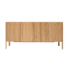 The Nell Sideboard | Light Oak by Wooden Stories features four vertical doors, a natural oak grain finish, and straight legs—a minimalist piece ideal for fans of Scandinavian design.