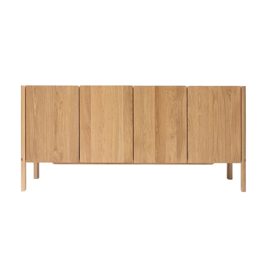 The Nell Sideboard | Light Oak by Wooden Stories features four vertical doors, a natural oak grain finish, and straight legs—a minimalist piece ideal for fans of Scandinavian design.