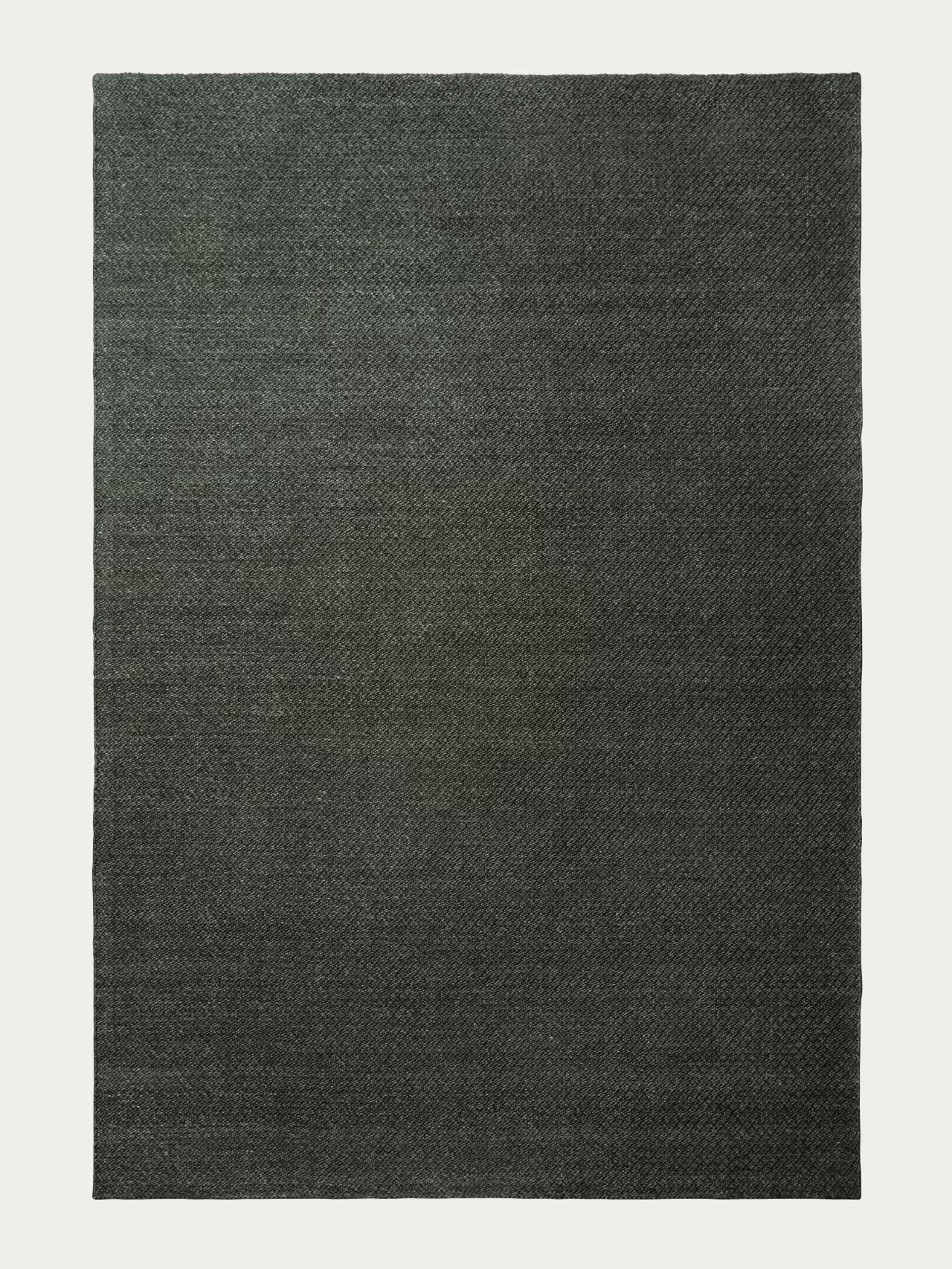 A rectangular Sherpa Rug - Kelp by Armadillo&Co, featuring a textured, hand-woven wool surface in dark gray, is displayed on a plain white background.