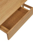 A close-up of the Author Desk | Light Oak by Wooden Stories shows an open drawer with an empty, brown textured interior.
