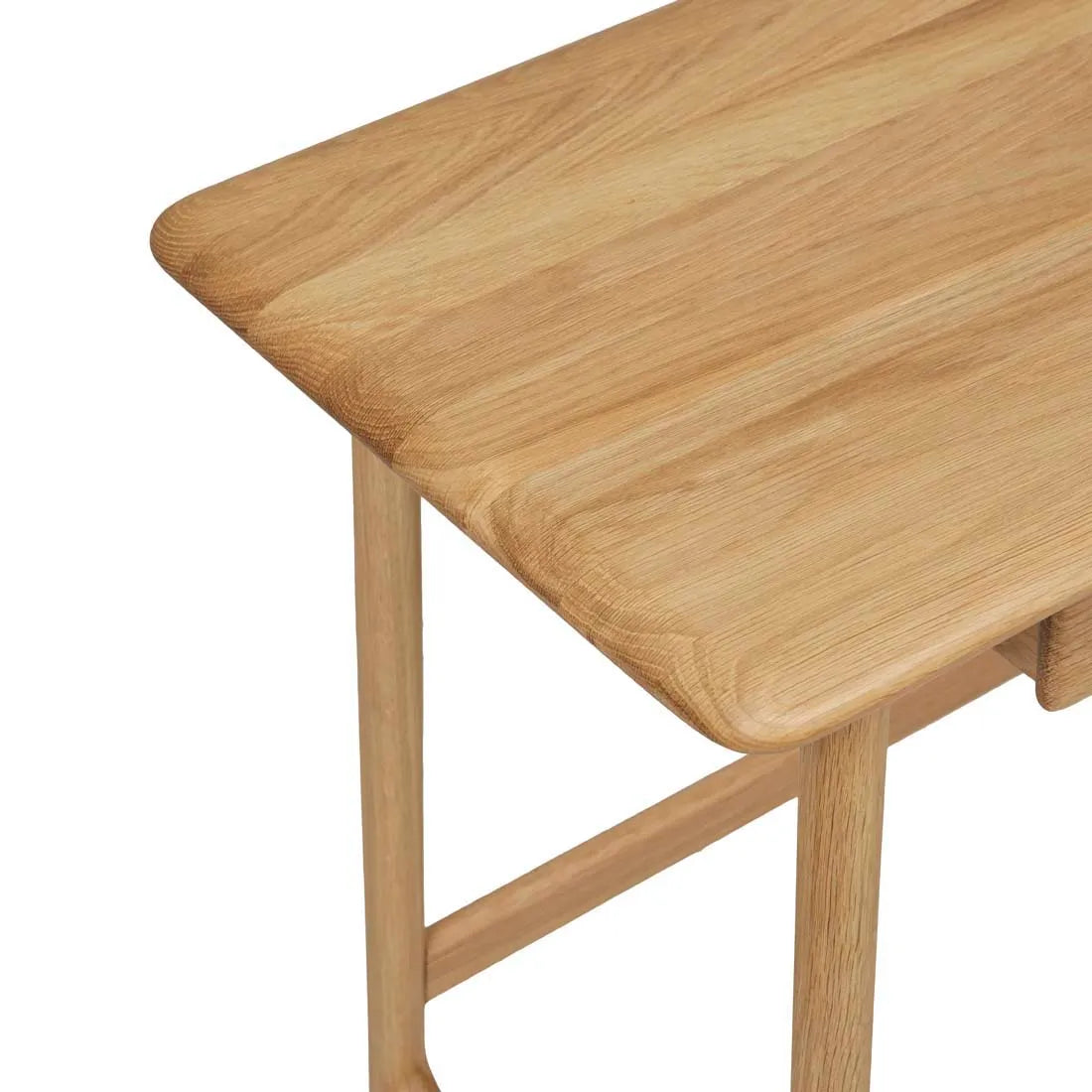 A close-up of the Author Desk | Light Oak by Wooden Stories shows its rounded edges, smooth surface, natural wood grain pattern, and sturdy contract-grade legs crafted from solid wood.