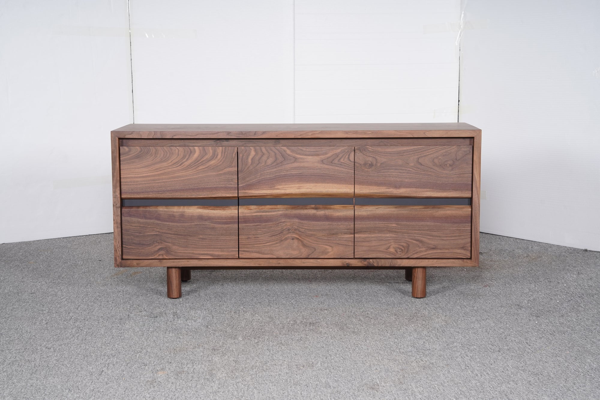 The SOBU Jupiter Sideboard - Walnut 3-door features a rich wood grain and short round legs, set on a grey carpet against a plain white background.