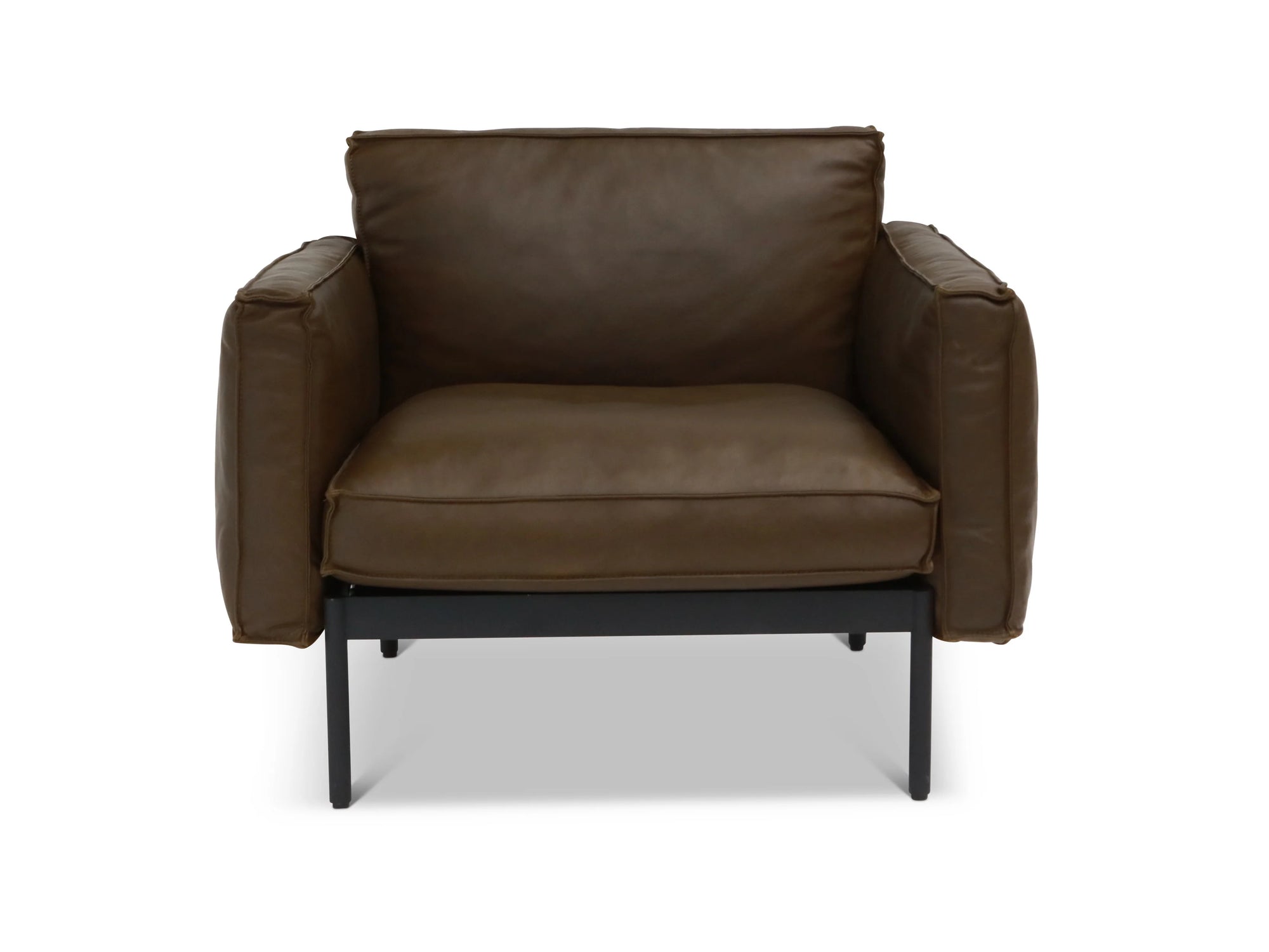 The Attendant Lounge Chair by Wooden Stories features generous seating, dark brown leather upholstery, wide armrests, French-seamed cushions, and a black metal frame with legs for modern style and comfort.