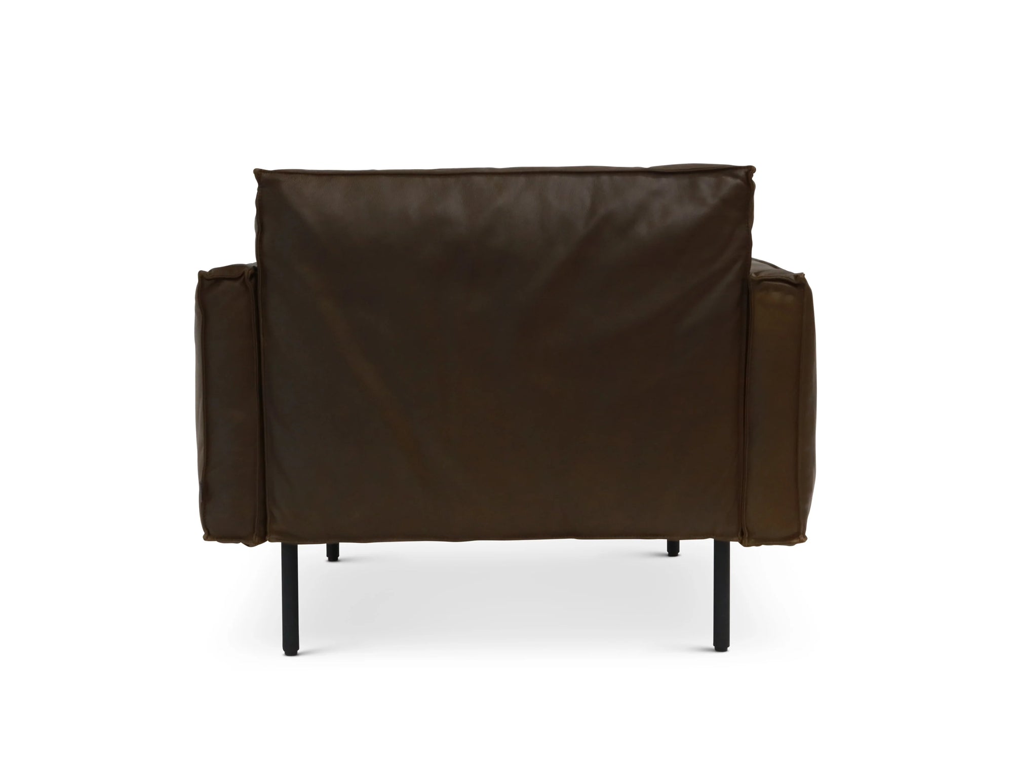 The Attendant Lounge Chair by Wooden Stories features dark brown leather, French seams, square arms, feather-padded panels, and slim black metal legs. Shown from the back against a white background.