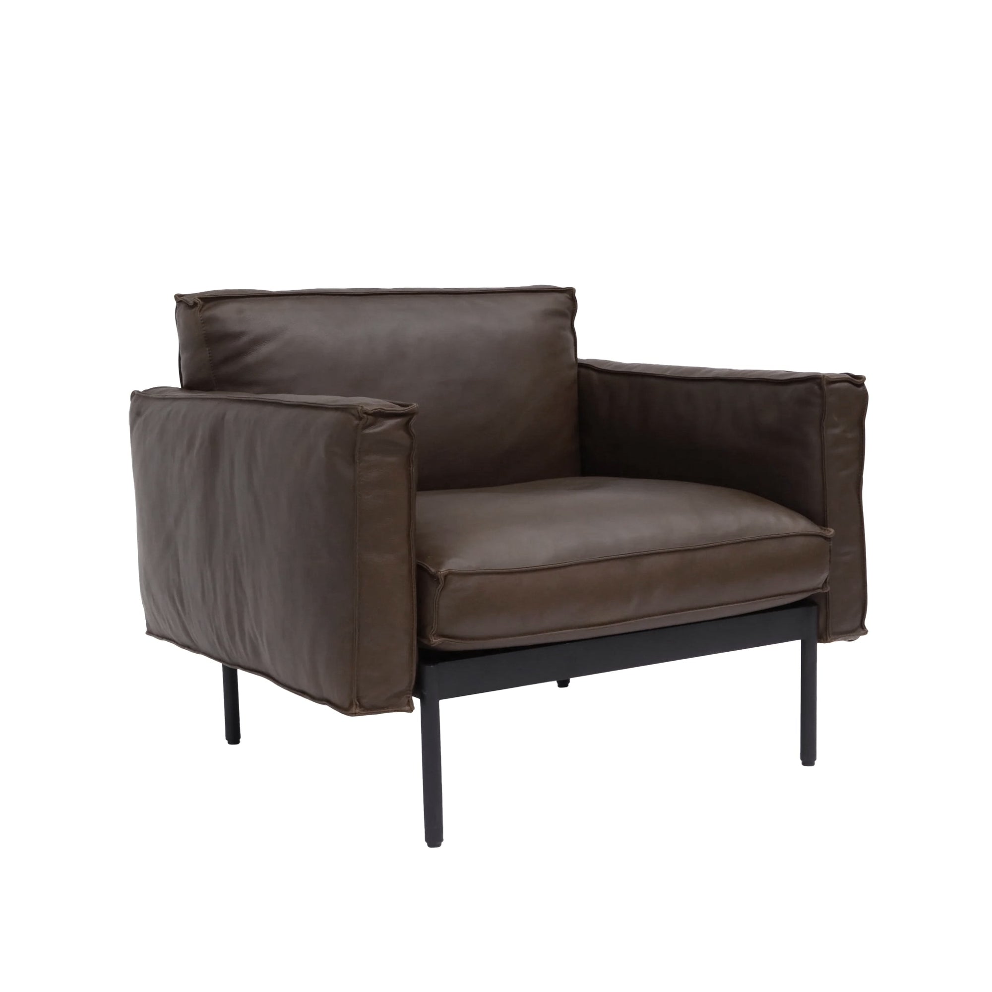 The Attendant Lounge Chair by Wooden Stories features dark brown leather upholstery, wide padded arms and backrest, and a sleek black metal frame with slender legs.
