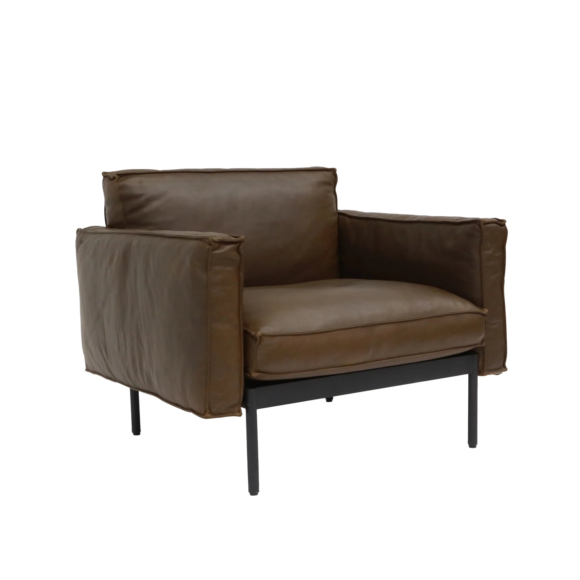 The Attendant Lounge Chair by Wooden Stories features brown leather cushions, black metal legs, wide padded armrests, and a boxy, minimalist design for modern comfort.