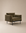 The Attendant Lounge Chair by Wooden Stories features olive green velvet, boxy cushions, and black metal legs, all expertly handcrafted. Shown here against a plain beige background.