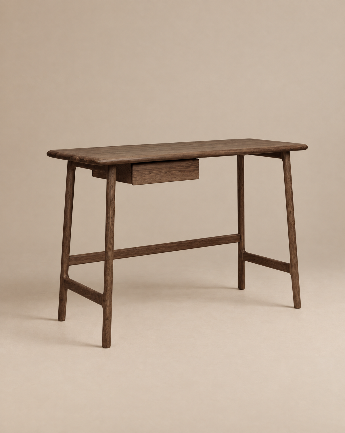 The Author Desk | Espresso Oak by Wooden Stories is crafted from solid wood and features a single central drawer, simple clean lines, and slightly angled legs. Set against a plain beige background, it’s an elegant addition to any Danish-inspired home office collection.