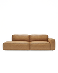 The Baker Modular Sofa | Leather • M1 by Wooden Stories is a modern, low-profile brown leather sofa with wide armrests and plush cushions, shown against a plain white background.