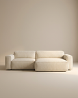 The Baker Modular Sofa | Fabric • M3 by Wooden Stories features a modern, light beige design with wide armrests and low backrests, perfectly suited for minimal, neutral-toned spaces as a standout piece of contemporary modular furniture.