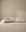 The Baker Modular Sofa | Fabric • M9 by Wooden Stories is a modern beige sectional with clean lines and plush cushions. Featuring a customizable design and left chaise lounge, it creates an inviting L-shaped seating arrangement.