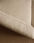 Close-up of the corner of the Baker Modular Sofa | Fabric • M9 by Wooden Stories, featuring visible seams, shown on a brown textured carpet.