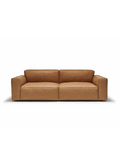 The Baker Sofa | Leather by Wooden Stories is a modern, rectangular tan leather sofa with wide armrests and plush seat and back cushions, shown against a plain white background.