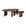 Two modern, overlapping Boomerang Coffee Tables by Ethnicraft, crafted in varnished teak with organic silhouettes and ribbed cylindrical legs. The nesting tables sit at different heights and showcase a rich wood finish.