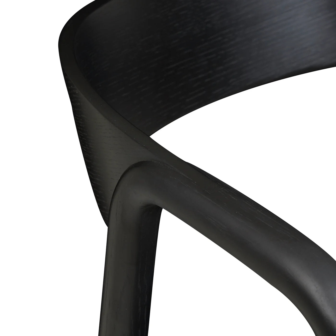 Close-up of the curved plywood backrest and armrest of the Inlay Dining Chair in Black Oak by Wooden Stories, showing its smooth texture and classic Danish-inspired lines against a white background.