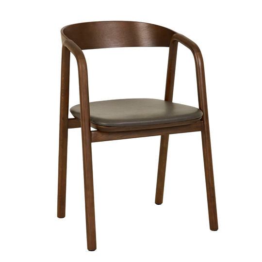 The Inlay Dining Chair by Wooden Stories features solid wood arms, a curved plywood backrest, angled armrests, and a dark leather cushioned seat in an elegant minimalist design with espresso oak.