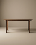 The Wooden Stories Cove Dining Table | Espresso Oak is a simple, modern piece made from solid American oak with rounded edges and cylindrical legs, shown against a plain beige background.