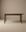The Wooden Stories Cove Dining Table | Espresso Oak is a simple, modern piece made from solid American oak with rounded edges and cylindrical legs, shown against a plain beige background.