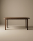 The Wooden Stories Cove Dining Table | Espresso Oak is a simple, modern piece made from solid American oak with rounded edges and cylindrical legs, shown against a plain beige background.