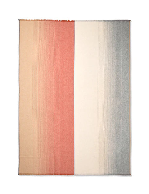 The Carte Postale Throw - Red Grey by Elvang Denmark features a rectangular design with a vertical split: the left side fades from tan to coral, the right transitions from cream to gray, and subtle fringe edges complete the look.