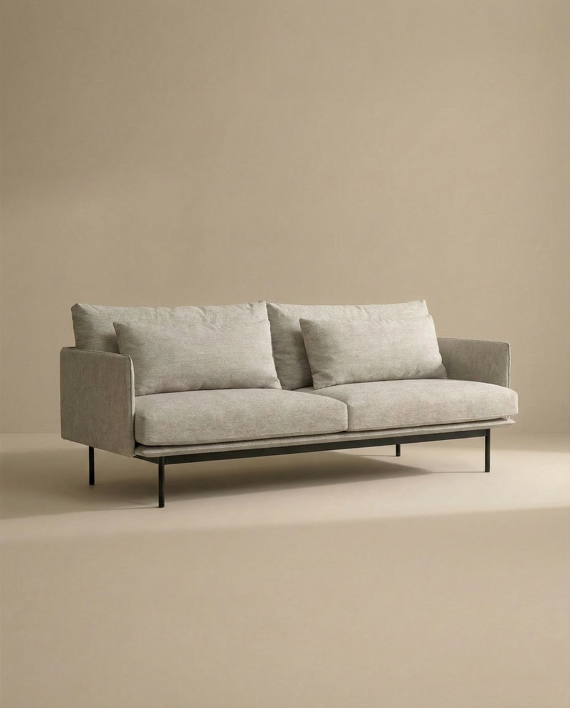 The SOBU Cherry Sofa | Fabric is a modern 3-seater with Danish lines, light gray upholstery, dual seat cushions, and slim black metal legs—ideal for contemporary living spaces against a neutral beige backdrop.