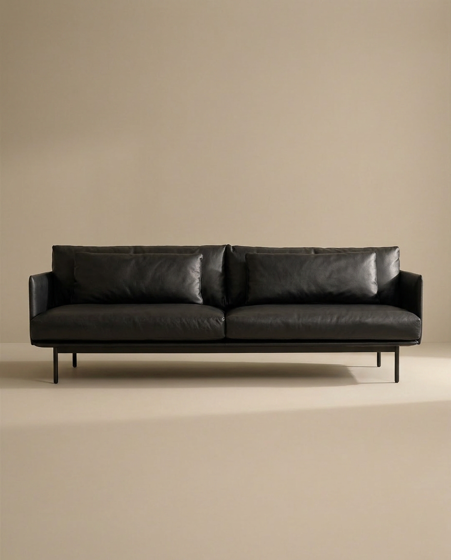 The SOBU Cherry Sofa | Leather features modern Danish lines, slim metal legs, low armrests, and two large cushions. Shown against a beige background, it's perfect for any contemporary living space.