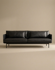 The SOBU Cherry Sofa | Leather features modern Danish lines, slim metal legs, low armrests, and two large cushions. Shown against a beige background, it's perfect for any contemporary living space.