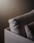 Close-up of the Cherry Sofa 79" | Fabric by Wooden Stories, featuring textured light brown cushions against a matching wall—creating a soft, minimalistic look ideal for modern spaces with subtle Danish-inspired lines.