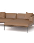 The Department Modular Sofa | Leather • M3 Right by Wooden Stories is a modern L-shaped tan leather sectional with two matching cushions, metal legs, and a solid wood base inspired by Danish collections, shown against a white background.