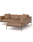 The Department Modular Sofa | Leather • M5 Right by Wooden Stories is a modern L-shaped brown leather sectional with a solid wood base, slim metal legs, and three matching cushions, shown on a white background.