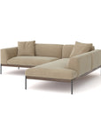 The Department Modular Sofa | Fabric • M5 Right by Wooden Stories is a modern beige L-shaped sectional with slim black metal legs, a solid wood base, and two matching cushions, inspired by Danish collections and shown on a white background.