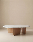The Eden Coffee Table | Wood & Stone by Wooden Stories features a modern oval Carrara marble top and three curved solid American oak legs, embodying Scandinavian simplicity.