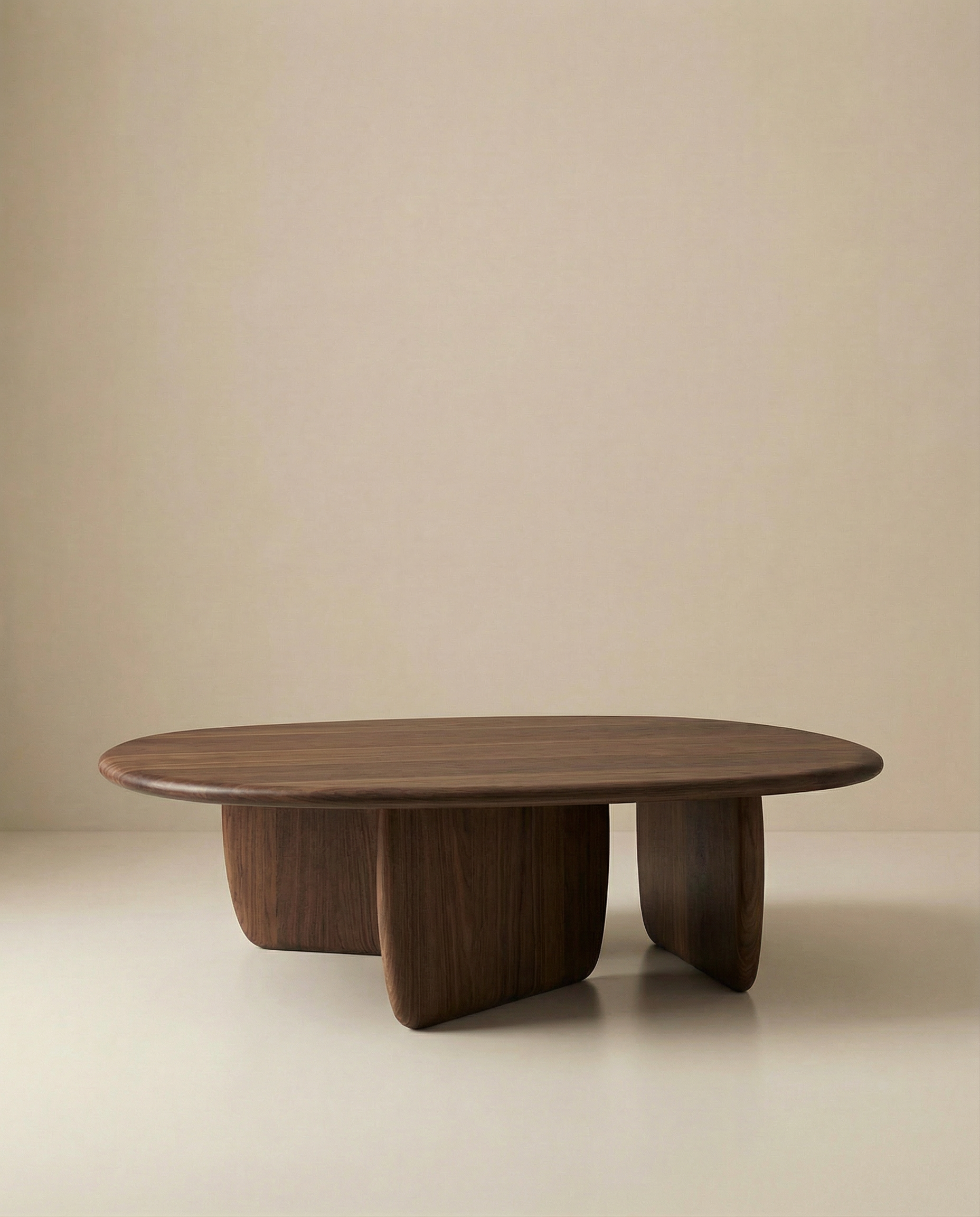 The Eden Coffee Table by Wooden Stories features a modern oval shape, solid wood construction, smooth edges, and thick curved legs that highlight Scandinavian simplicity against a plain beige background.