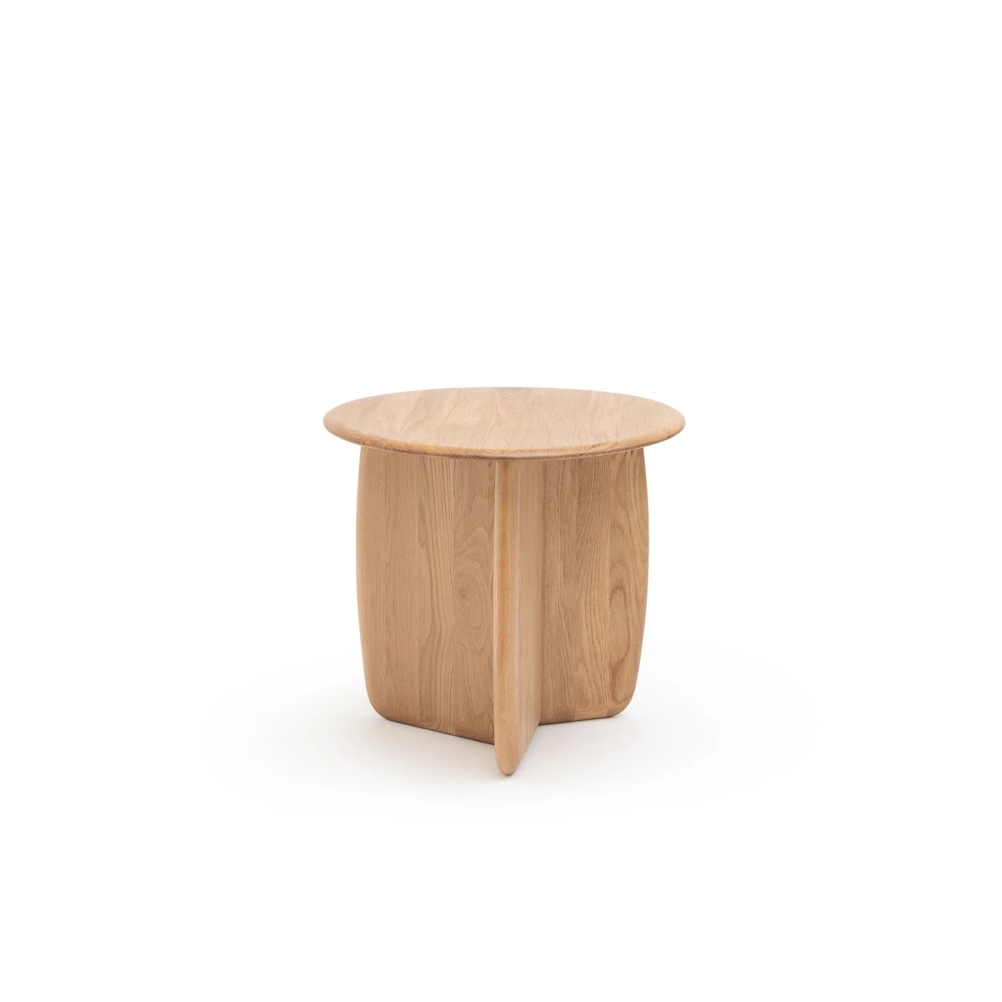 The Eden Side Table by Wooden Stories is a small, round Scandinavian piece with a smooth top and three curved legs, crafted from light oak, showcased against a plain white background.