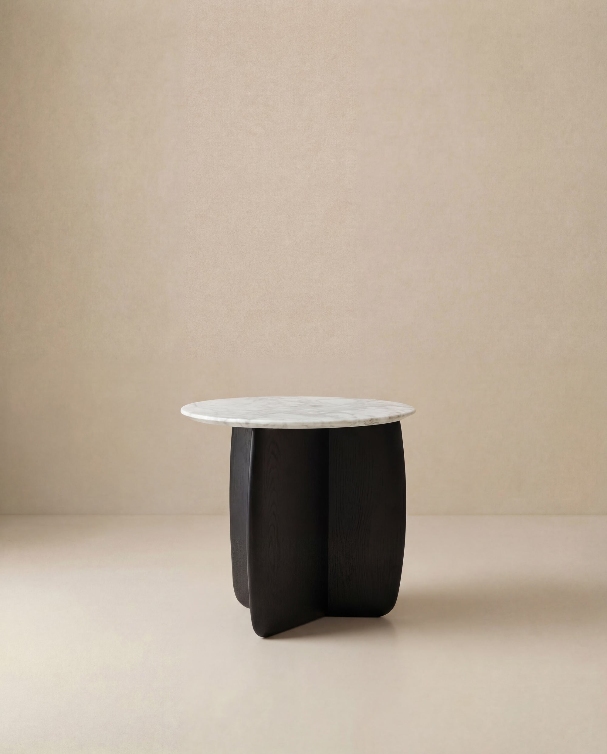 The Eden Side Table | Stone Top by Wooden Stories features a modern round white marble top and a sculptural solid American oak base, set against a neutral beige background to embody Scandinavian simplicity.
