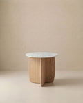 The Eden Side Table | Stone Top by Wooden Stories features a white marble top and light American oak base with intersecting curved panels, embodying Scandinavian simplicity against a beige backdrop.