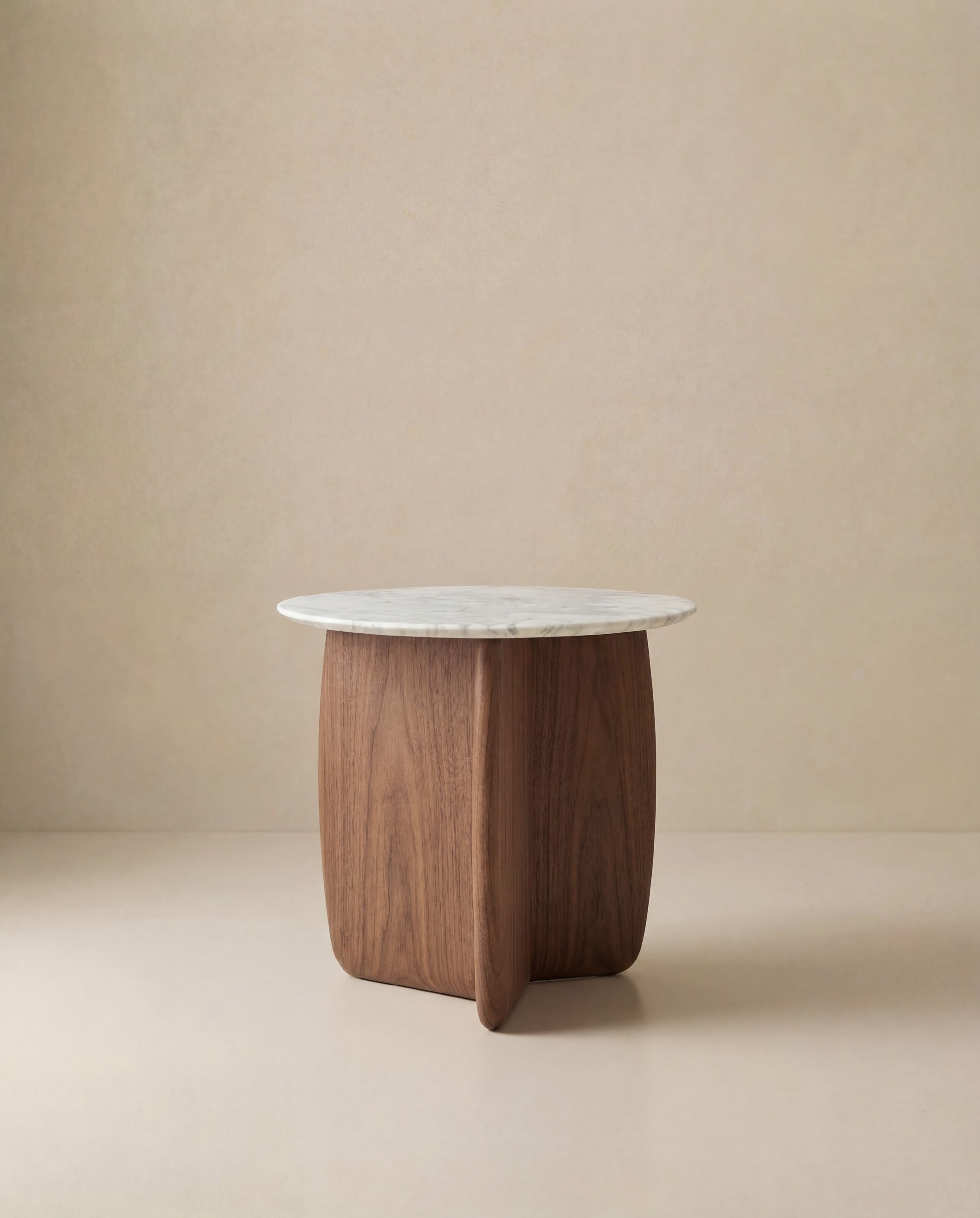 The Eden Side Table | Stone Top by Wooden Stories features a round white marble top and a curved American oak base, displayed against a plain beige background.