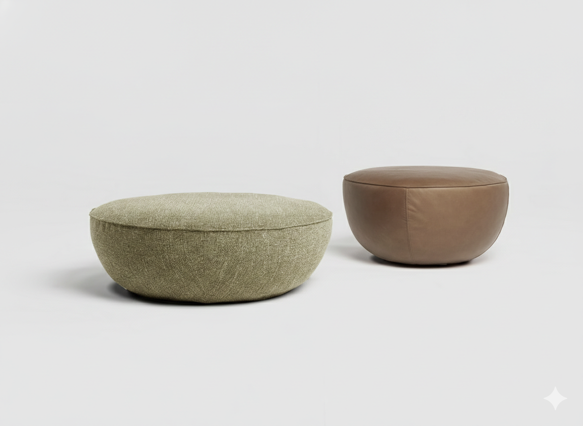 Two round ottomans from the Wooden Stories collection sit on a plain white background: one is a Fable Ottoman in light green fabric, and the other is in brown leather.