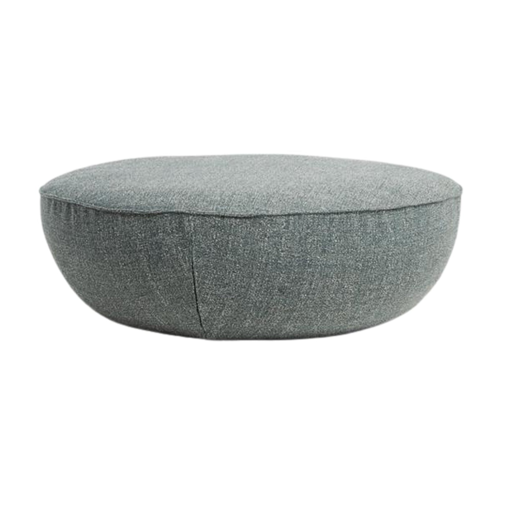 The Wooden Stories Fable Ottoman | Fabric is a round, grey piece with a smooth, minimalist design and soft look, versatile as a floor cushion or pouf. Shown on a white background.