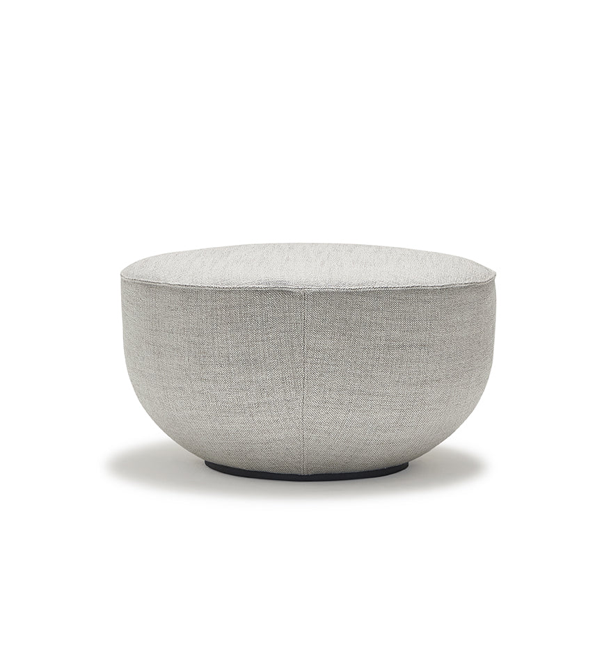 The Wooden Stories Fable Ottoman | Fabric features a round, light gray design with a smooth, curved shape and flat top, inspired by Danish furniture, shown against a plain white background.
