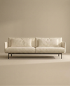 The Cherry Sofa | Fabric by Wooden Stories is a modern, minimalist 3-seater featuring Danish-inspired lines, plush cushions, and slim black metal legs—an elegant fit for any contemporary living space.