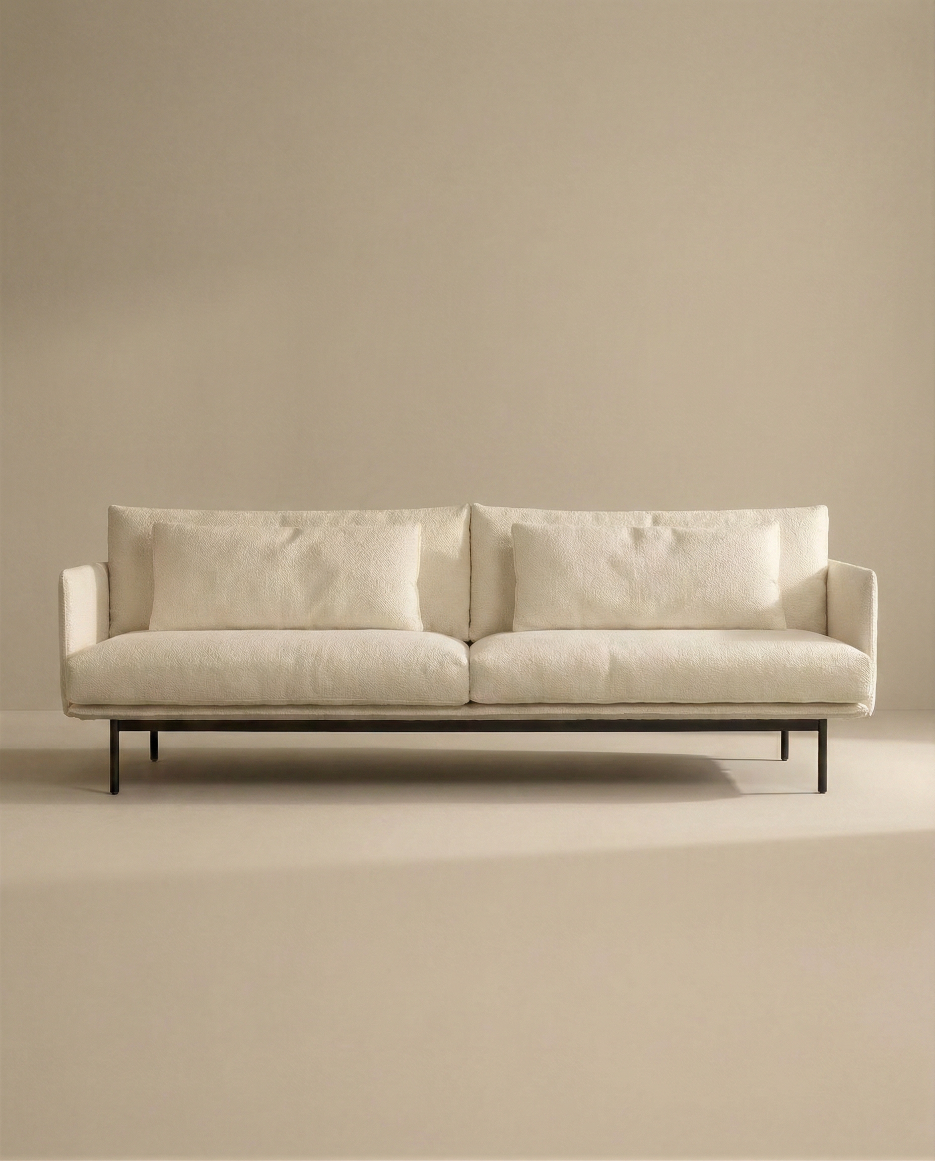 The Cherry Sofa | Fabric by SOBU is a modern, minimalist 3-seater with slim black metal legs and cream upholstery. Distinct Danish lines and two large seat/back cushions make it perfect for any contemporary living space.