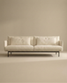 The Cherry Sofa | Fabric by Wooden Stories is a modern, minimalist 3-seater featuring Danish-inspired lines, plush cushions, and slim black metal legs—an elegant fit for any contemporary living space.